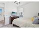 Cozy bedroom with natural light, neutral tones, and a TV offers a calming and comfortable space at 670 S Beebe St, Gilbert, AZ 85296