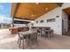 This covered outdoor grilling and dining area offers a perfect spot for entertaining friends and Gathering within the community at 670 S Beebe St, Gilbert, AZ 85296