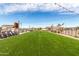 Community outdoor area featuring a grassy lawn, fireplace, and comfortable lounge seating at 670 S Beebe St, Gilbert, AZ 85296