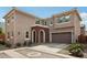 Charming two-story home featuring a brick arched entryway and attached two-car garage at 670 S Beebe St, Gilbert, AZ 85296