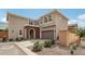 Two-story home with a brick-arched entryway, attached two-car garage and well-maintained landscaping at 670 S Beebe St, Gilbert, AZ 85296