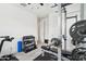 Functional home gym equipped with weightlifting station, dumbbells, and ceiling fan at 670 S Beebe St, Gilbert, AZ 85296