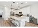 Modern kitchen with white cabinets, an island with seating, and stainless steel appliances at 670 S Beebe St, Gilbert, AZ 85296