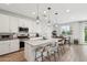 Modern kitchen with white cabinets, a large island with seating, and stainless steel appliances at 670 S Beebe St, Gilbert, AZ 85296