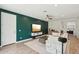 Inviting living room features modern decor, a large green accent wall, and wood-look tile floors at 670 S Beebe St, Gilbert, AZ 85296