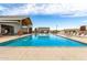 A pristine community pool offers a refreshing escape, surrounded by lounge chairs for relaxation and enjoyment under the sun at 670 S Beebe St, Gilbert, AZ 85296