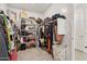 Spacious walk-in closet with custom shelving, ample storage and a carpeted floor at 670 S Beebe St, Gilbert, AZ 85296