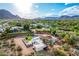 An aerial view showcases the property with its unique landscaping and mountain views at 6701 E San Miguel Ave, Paradise Valley, AZ 85253