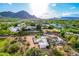 An aerial view showcases the property with its unique landscaping and mountain views at 6701 E San Miguel Ave, Paradise Valley, AZ 85253
