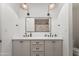 Bright bathroom featuring dual sinks, tile flooring, and a shower with light-colored tile at 6701 E San Miguel Ave, Paradise Valley, AZ 85253