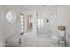Bright bathroom boasting a glass-enclosed shower, decorative window, marble floors, and a comfortable bench at 6701 E San Miguel Ave, Paradise Valley, AZ 85253