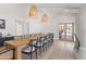 Bright dining room with an extra long table, seating for fourteen, stylish fixtures and a view of the backyard at 6701 E San Miguel Ave, Paradise Valley, AZ 85253