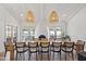 Spacious dining room with long table, seating for twelve, and elegant lighting fixtures with a view of the pool at 6701 E San Miguel Ave, Paradise Valley, AZ 85253