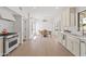 Charming kitchen with white cabinetry, stainless steel appliances, breakfast nook, and plenty of natural light at 6701 E San Miguel Ave, Paradise Valley, AZ 85253
