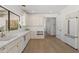 Bright kitchen featuring white cabinets, quartz countertops, gold fixtures, and light wood flooring at 6701 E San Miguel Ave, Paradise Valley, AZ 85253