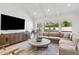 Bright living room with vaulted ceilings, wood floors, a large sofa, and modern furniture at 6701 E San Miguel Ave, Paradise Valley, AZ 85253