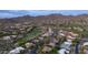 Aerial view of houses in a golf course community surrounded by the natural desert landscape at 7130 E Saddleback St # 58, Mesa, AZ 85207