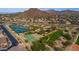 This aerial shows community parks and recreational courts surrounded by mountain views offering active lifestyle amenities at 7130 E Saddleback St # 58, Mesa, AZ 85207