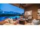 Inviting covered back patio features comfortable seating, a fire pit, and a beautiful view of the pool at 7130 E Saddleback St # 58, Mesa, AZ 85207