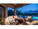 Beautiful covered back patio boasts ample seating, a fire pit, and serene views of the pool at 7130 E Saddleback St # 58, Mesa, AZ 85207