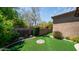 Manicured backyard with artificial turf and desert landscaping at 7130 E Saddleback St # 58, Mesa, AZ 85207
