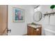 Bathroom featuring a wooden vanity and a round mirror at 7130 E Saddleback St # 58, Mesa, AZ 85207