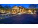 Elegant clubhouse entrance with stone columns, porte cochere, and professional landscaping at 7130 E Saddleback St # 58, Mesa, AZ 85207
