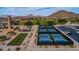 An aerial view features a community park with pickleball courts, a bocce ball court and ample parking surrounded by mountain views at 7130 E Saddleback St # 58, Mesa, AZ 85207