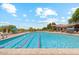 A community pool is showcased with lane markers and lounge chairs offering residents a luxurious and relaxing outdoor experience at 7130 E Saddleback St # 58, Mesa, AZ 85207