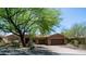 Charming home with a paver driveway, three-car garage and stone accents, all set beneath a sunny sky at 7130 E Saddleback St # 58, Mesa, AZ 85207
