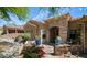 Close up of a charming home with an entry courtyard, stone accents, and desert landscaping at 7130 E Saddleback St # 58, Mesa, AZ 85207