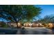 Charming home with a paver driveway, three-car garage and stone accents, all set beneath a twilight sky at 7130 E Saddleback St # 58, Mesa, AZ 85207