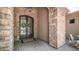 Elegant front entrance featuring arched double doors with iron detailing and stone accents at 7130 E Saddleback St # 58, Mesa, AZ 85207