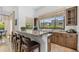 Eat-in kitchen with bar, granite countertops, seating and a large window that offers views of the yard at 7130 E Saddleback St # 58, Mesa, AZ 85207