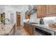 Kitchen featuring granite counters, stainless steel appliances, custom cabinetry, and tile backsplash at 7130 E Saddleback St # 58, Mesa, AZ 85207