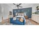The bedroom includes a stylish blue settee, light walls, and a large area rug at 7130 E Saddleback St # 58, Mesa, AZ 85207