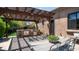 Shaded outdoor kitchen with grill and dining table, perfect for outdoor entertaining at 7130 E Saddleback St # 58, Mesa, AZ 85207