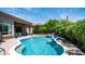 Inviting pool with waterfall feature and lush landscaping enhances the backyard oasis at 7130 E Saddleback St # 58, Mesa, AZ 85207