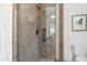 Tiled shower with glass door, rainfall shower head, built-in niche, and dark hardware at 7130 E Saddleback St # 58, Mesa, AZ 85207