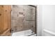 Tile shower with glass door, built-in niche, and chrome hardware at 7130 E Saddleback St # 58, Mesa, AZ 85207