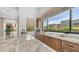 Close-up on wet bar with stainless faucet, granite counters, and a nice view through the window at 7130 E Saddleback St # 58, Mesa, AZ 85207