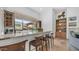 Wet bar featuring granite countertops, wood cabinets, and window views to the back yard at 7130 E Saddleback St # 58, Mesa, AZ 85207