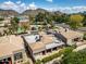 An aerial shot of this home features a flat roof and a mountain range in the background at 715 W Townley Ave, Phoenix, AZ 85021