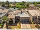 An aerial view showcases this home's tile roof, desert landscaping and attached two car garage at 715 W Townley Ave, Phoenix, AZ 85021