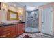 An elegant bathroom with a glass shower, marble, and shaker cabinets at 715 W Townley Ave, Phoenix, AZ 85021