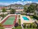 Aerial view of the tennis court and community pool with mountain views in the background at 715 W Townley Ave, Phoenix, AZ 85021