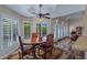 A cozy dining room featuring an oval table, leather chairs, and a decorative rug under a ceiling fan at 715 W Townley Ave, Phoenix, AZ 85021
