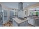 A sleek kitchen featuring stainless appliances, a breakfast table, and shaker cabinets at 715 W Townley Ave, Phoenix, AZ 85021