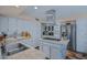 A modern kitchen featuring white cabinets, stainless steel appliances, and granite countertops at 715 W Townley Ave, Phoenix, AZ 85021