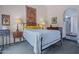 Comfortable main bedroom with a king bed, tapestry wall hanging, and a view to the ensuite bathroom at 715 W Townley Ave, Phoenix, AZ 85021